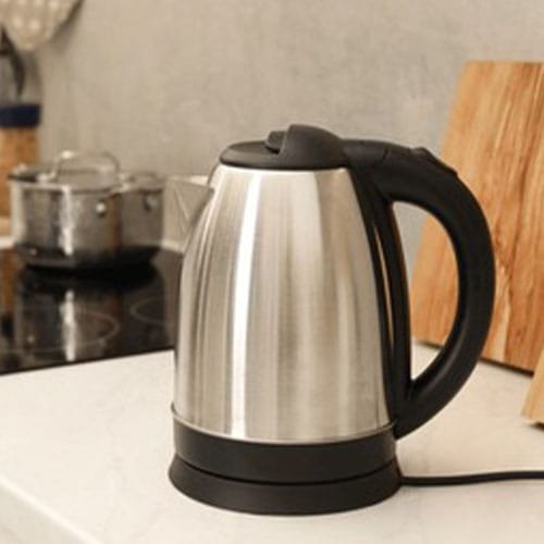 Modern electric kettle on counter in kitchen