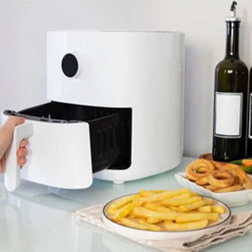 Woman cooking with modern Air fryer